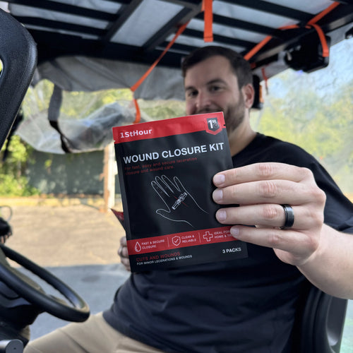 Man holding a 1st Hour Wound Closure Kit package inside his vehicle
